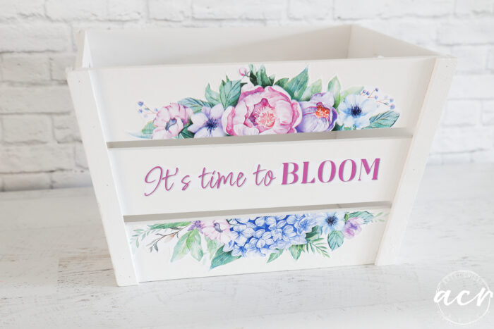 white wood crate with colorful flowers on front