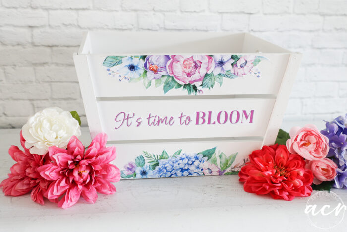 white wood crate with colorful flowers