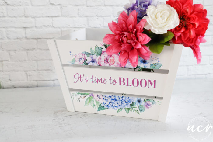 white wood crate with colorful flowers inside