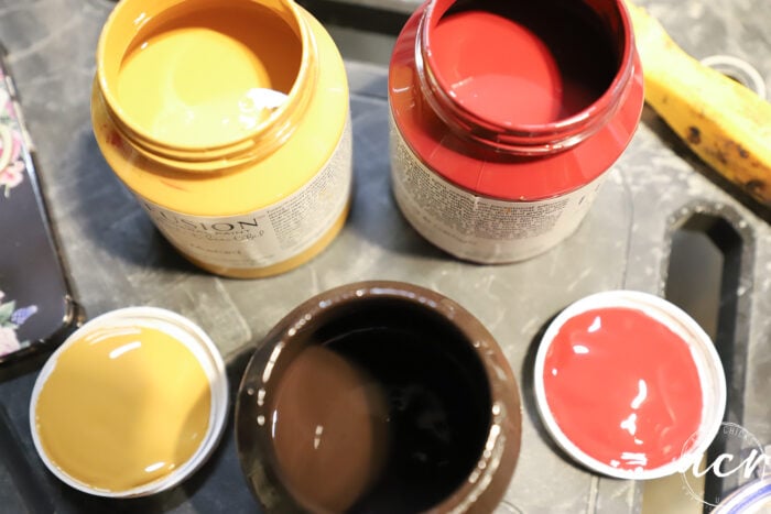 open jars of paint on table