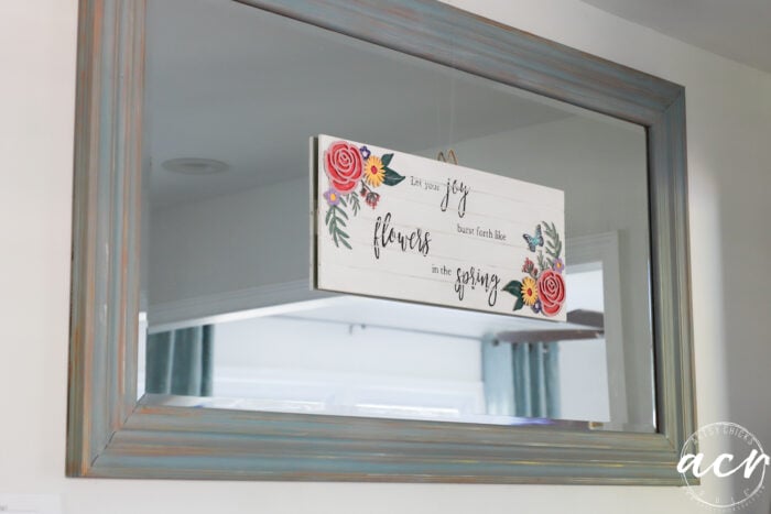 sign hanging on mirror