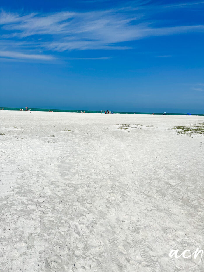 huge beach with white sand and blue skies