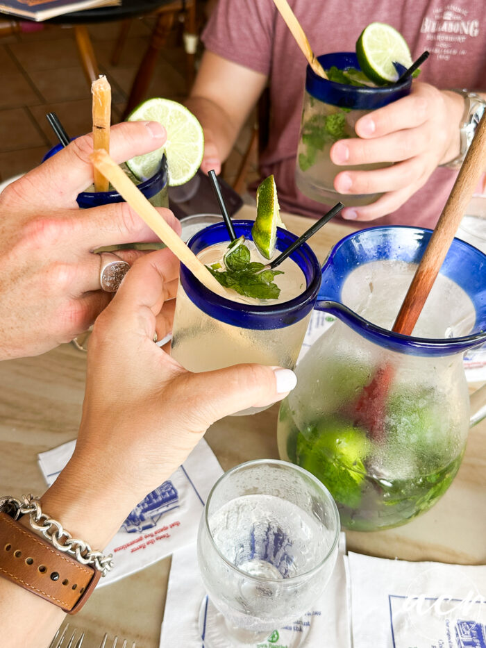 saying cheers with mojitos