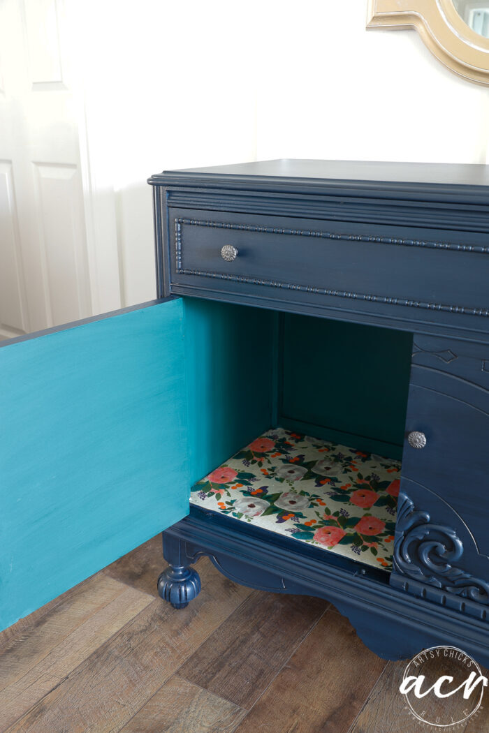 painted cabinet finished with door open revealing interior decoupage and paint