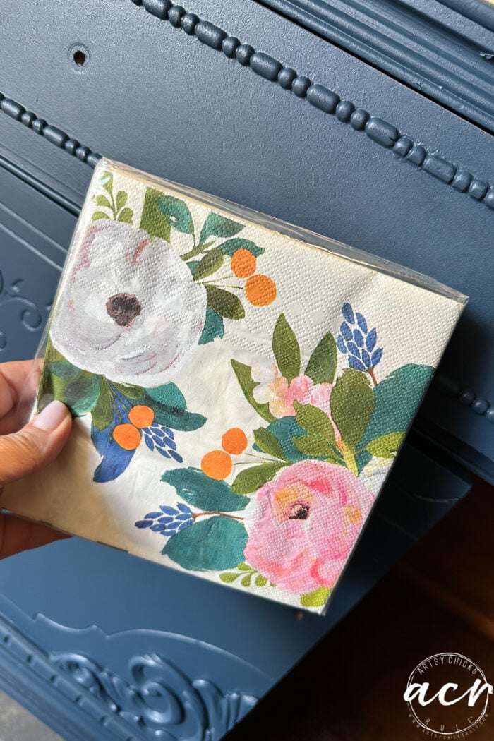 blue cabinet with colorful flowered napkins