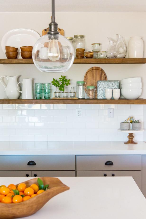 small wood shelves with various kitchen items and cutting boards