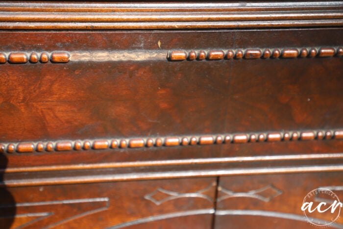 up close of missing trim piece on wood furniture