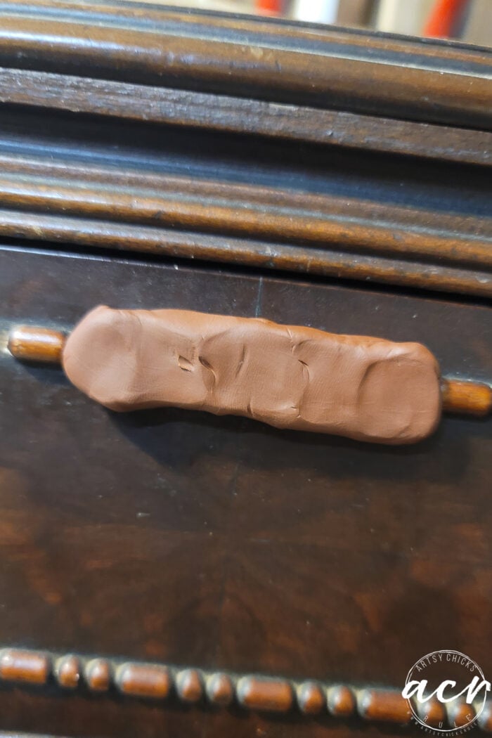 using brown clay to make a mold of existing trim