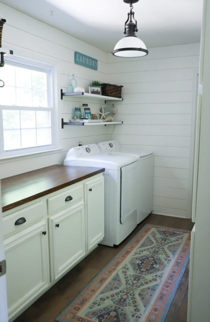 white shiplap laundry with colorful rug