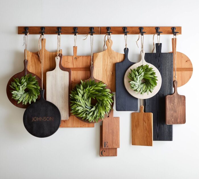 cutting boards hanging from a wood rack and metal hooks