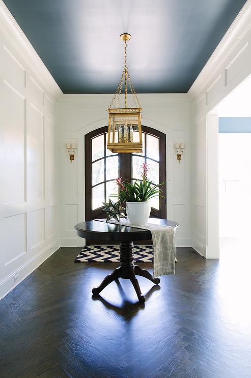 foyer entry with dark blue ceiling and white walls