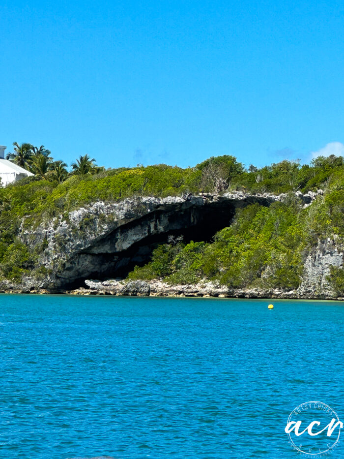 blue green water and a cave