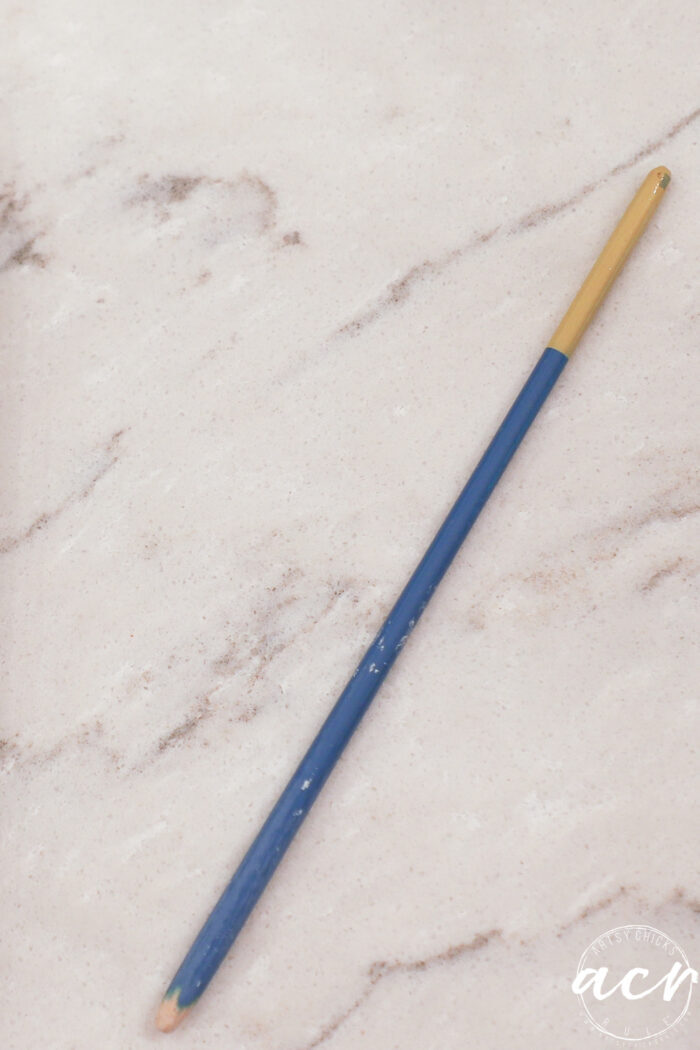half of a thin paint brush stick