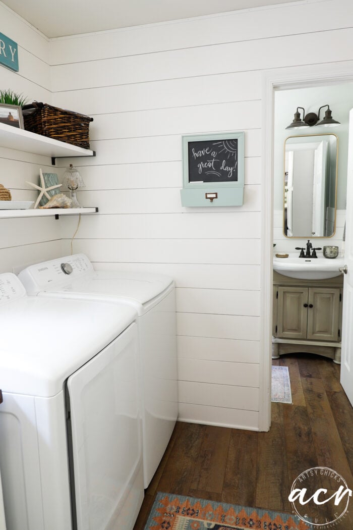 chalkboard message on shiplap wall in laundry room