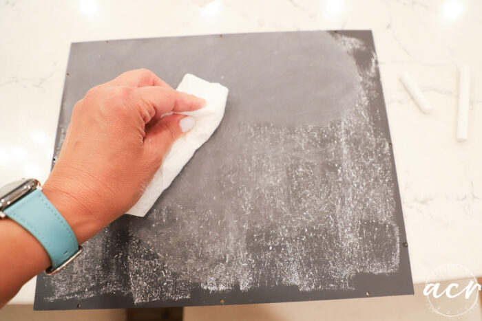 rubbing the chalk into the dry paint with a paper towel