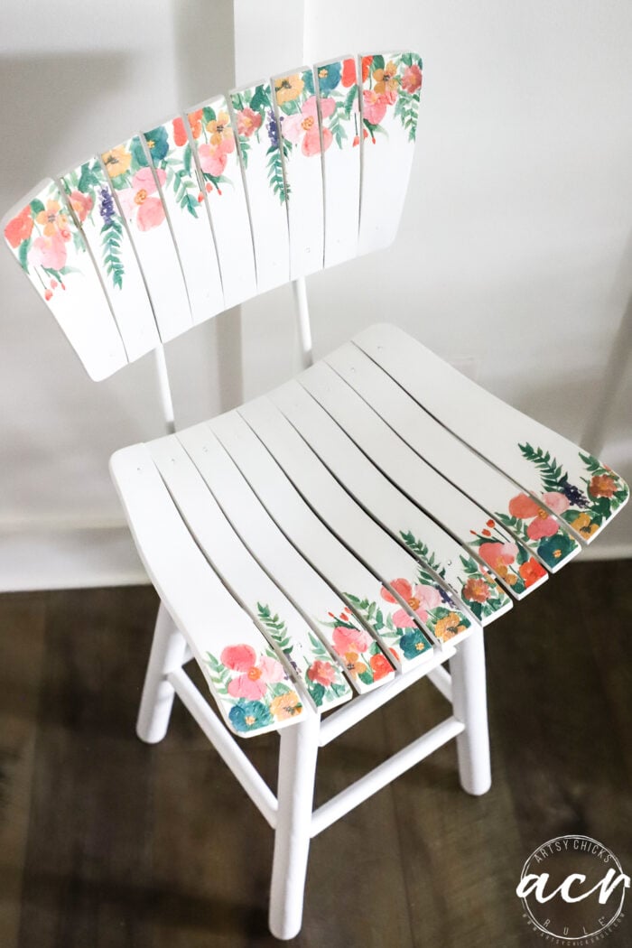 floral napkins on a white wood stool
