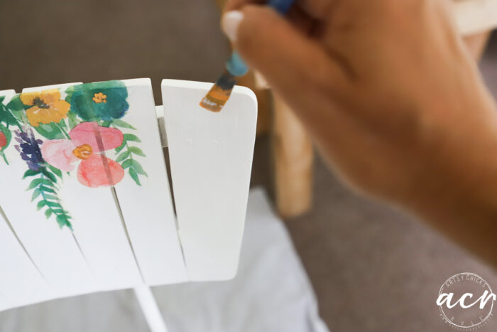 brushing on the decoupage gel onto the wood bar stool