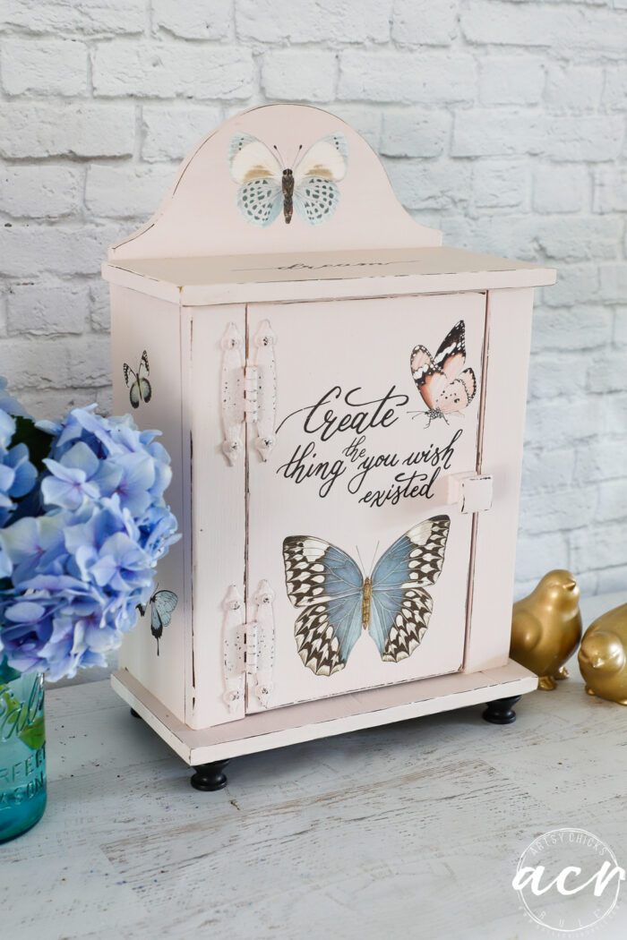 pink cabinet with black feet and butterflies transfers