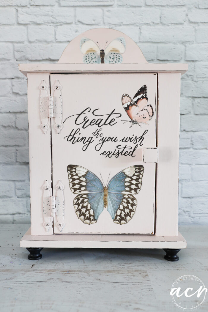 front view of pink cabinet with butterflies and writing, create the thing you wish existed