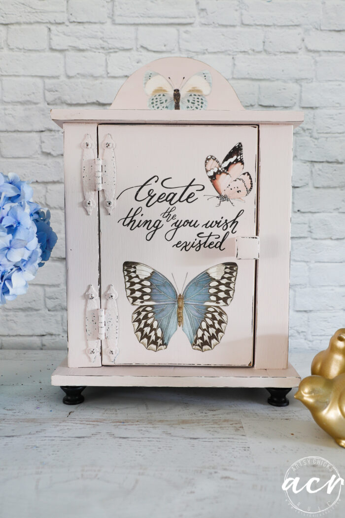 pink small cabinet with butterflies