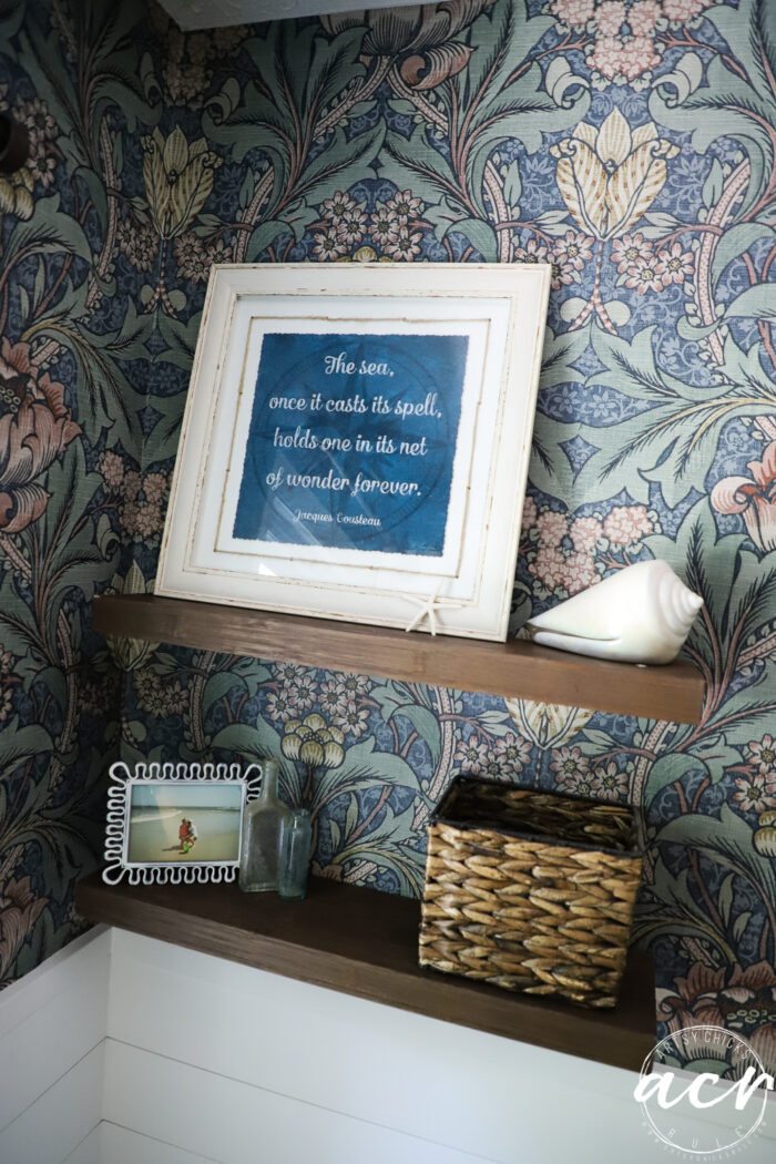 wood shelves with blue print white frame, seashells, picture and basket