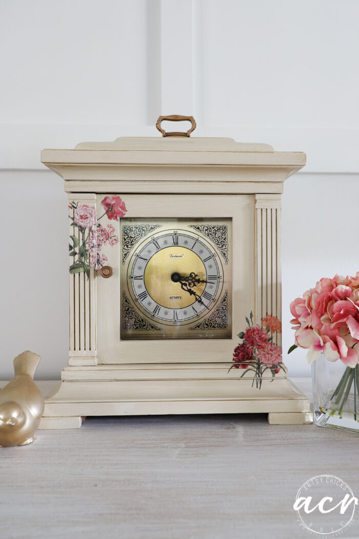 finished mantel clock with floral transfers and gold bird and pink flowers in glass vase for decor