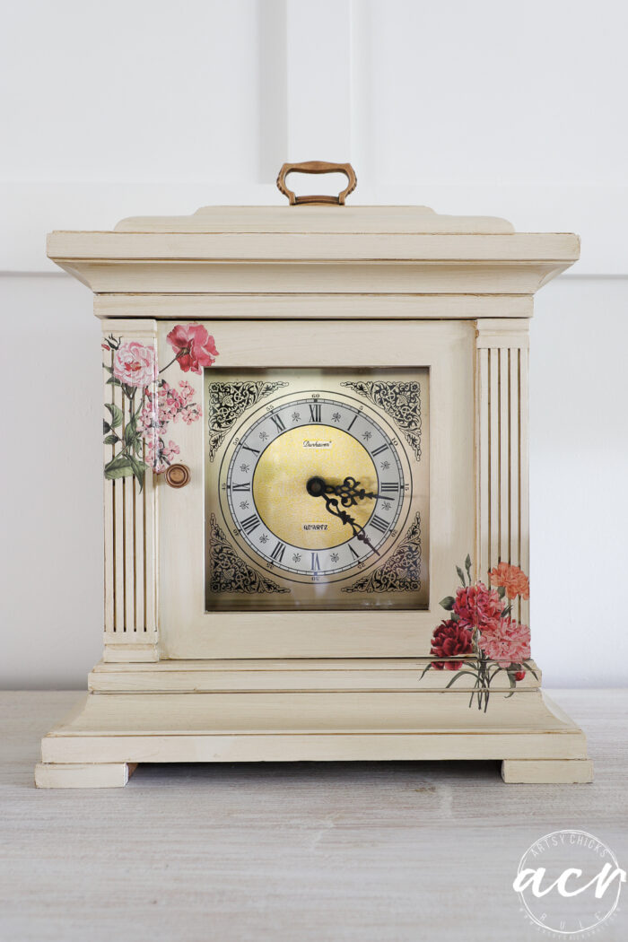 antique glazed mantel clock with pink flower transfers on table