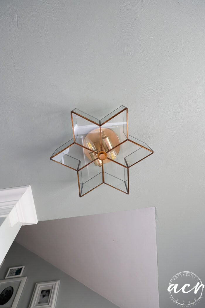 star shaped glass and gold light fixture