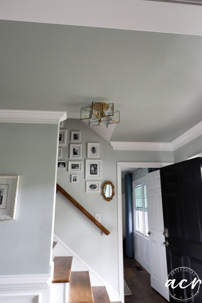 dark ceiling and photos on wall going up stairs