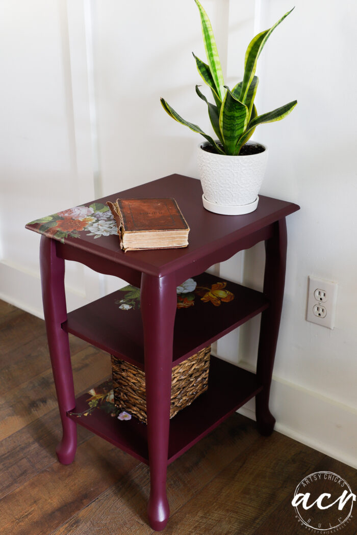 Elderberry painted small table with green plant and book, with basket