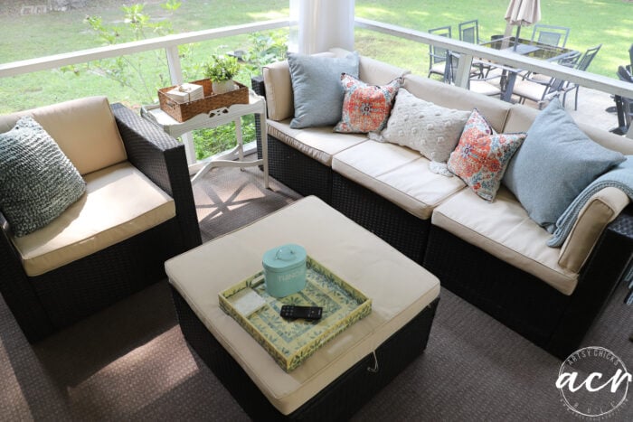 tan and brown outdoor set with blue, white and orange pillows