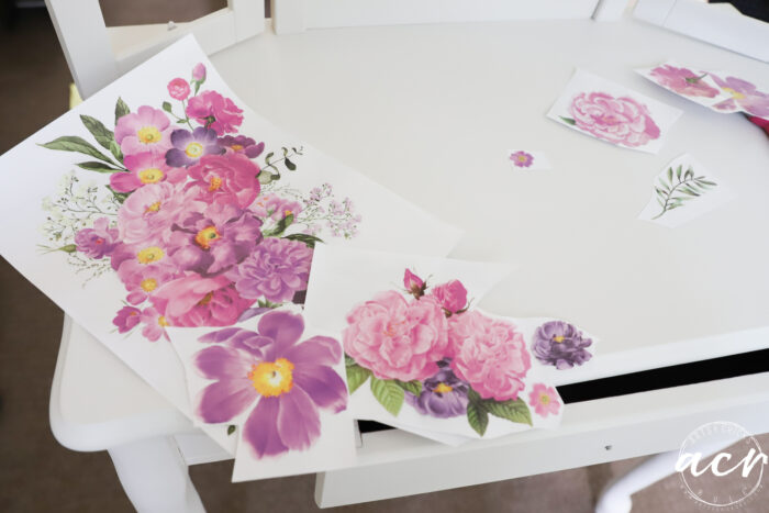 white dressing table with pink and purple flowered transfers laying on top