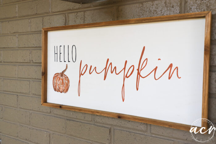 hello pumpkin sign on brick wall