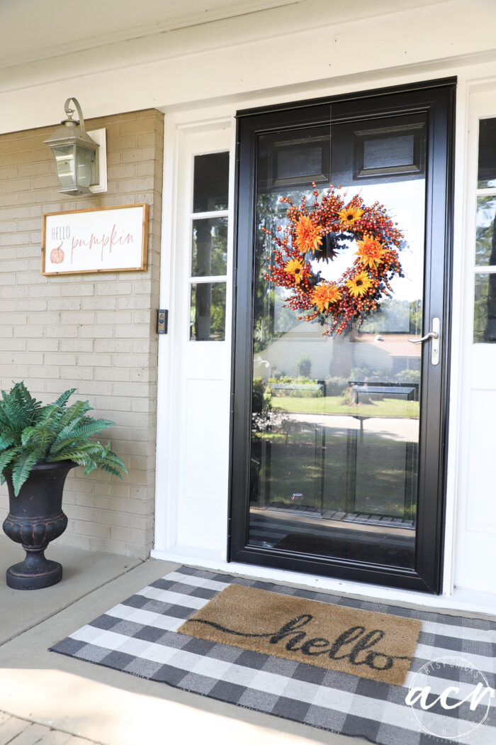 orange wreath on black front door