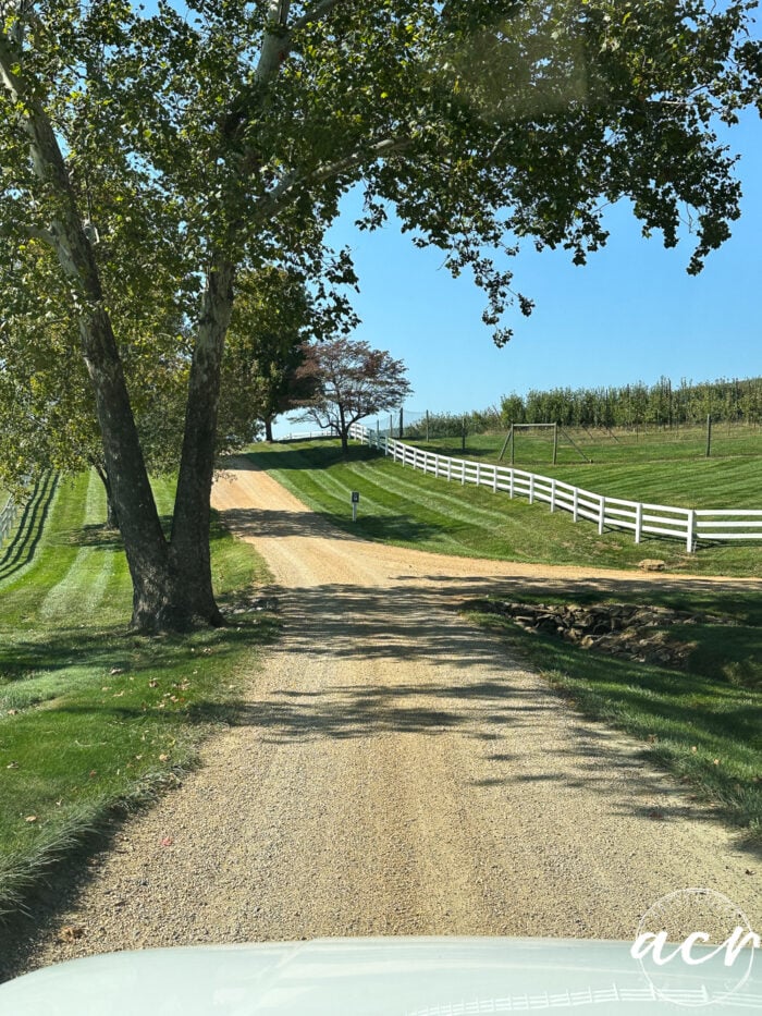 gravel drive with white picket fence