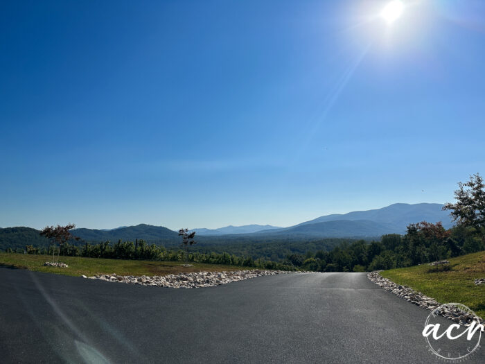 road at the top of the mountain looking out at the mountain range