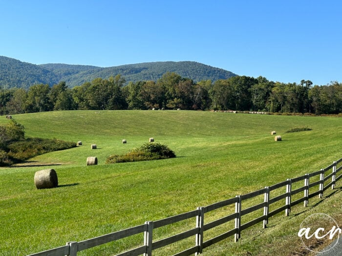 moutains and rolling green grassy hills and bails of hay