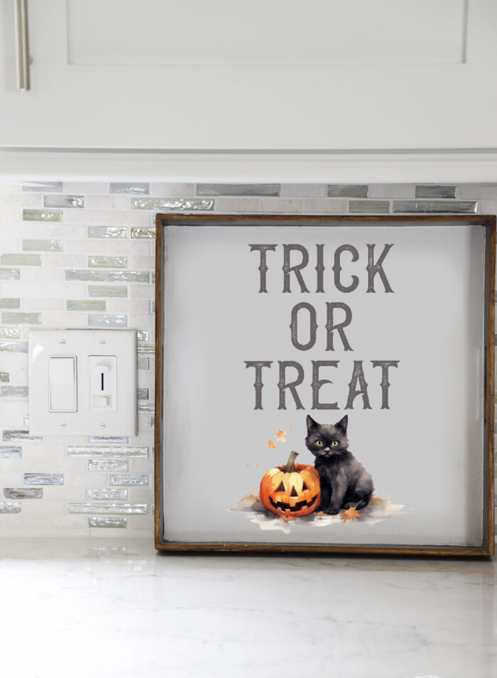 trick or treat sign with black cat and pumpkin