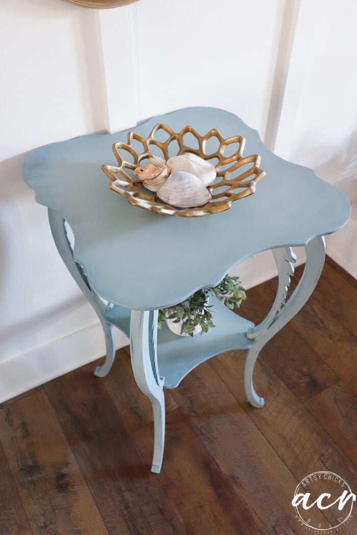 top side view of blue table with gold dish