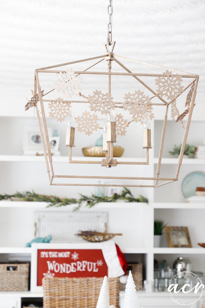 gold light fixture with gold snowflakes