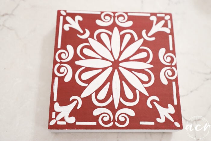 stencil with embossing paste and red block