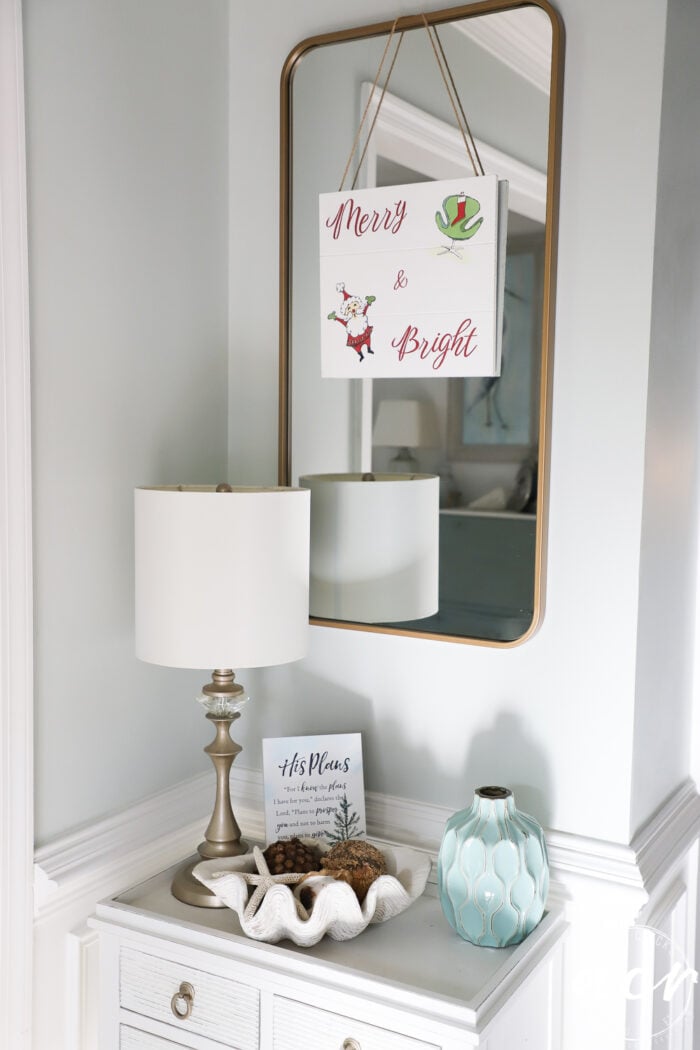 merry and bright sign hanging on gold mirror