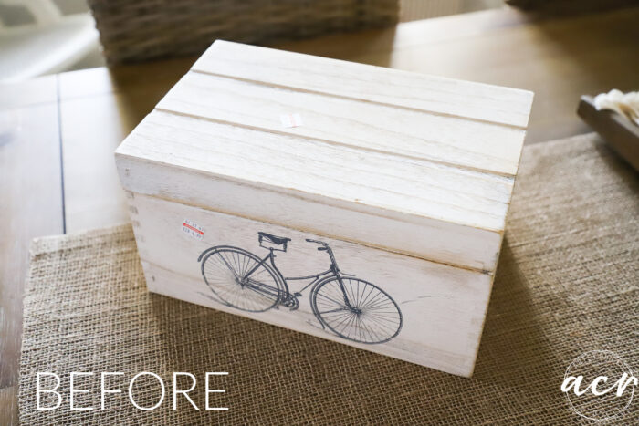 white washed wood box with bicycle on front