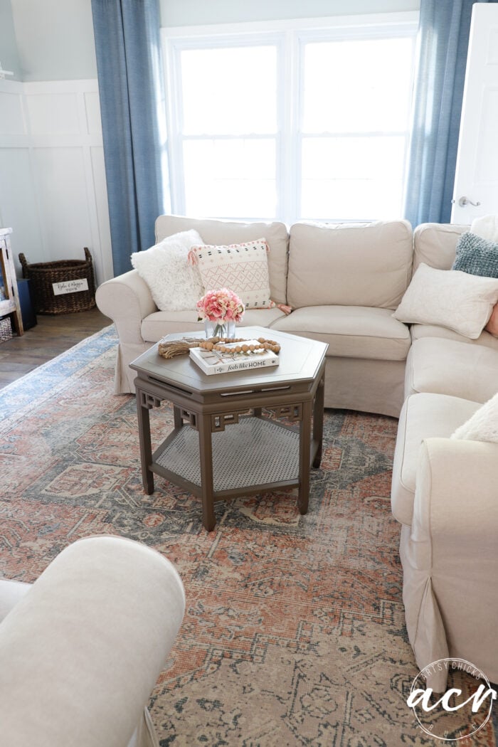 tan couch with table decorated 