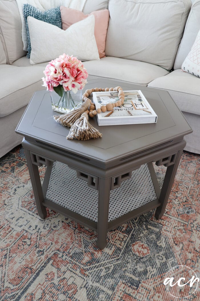 pretty little table decorated in front of couch