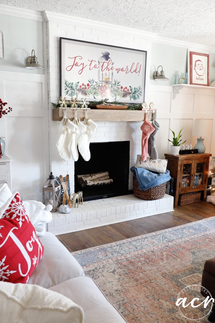 fireplace and mantel with tv over and stockings
