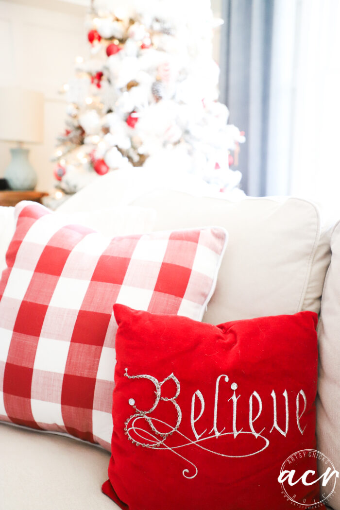 red believe pillow and red and white check pillow 