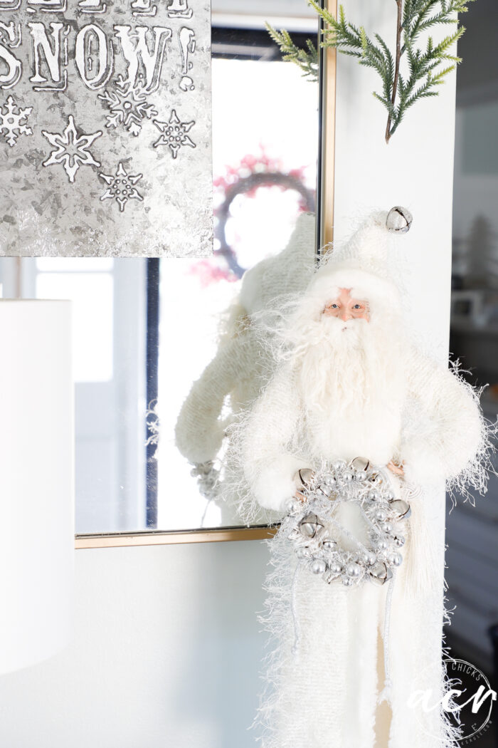 white robed santa in front of mirror