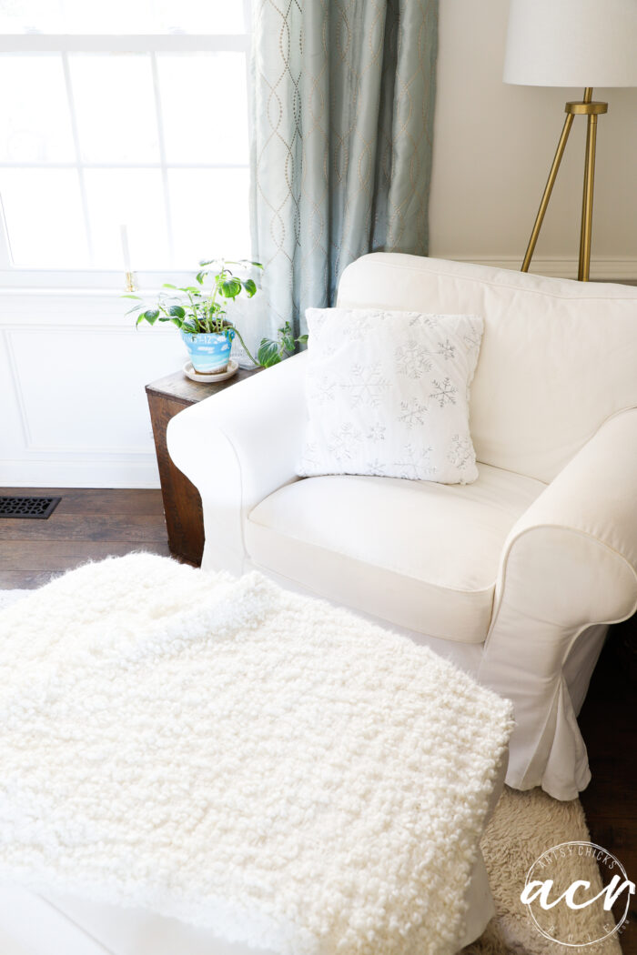 white chair, white pillow, white throw