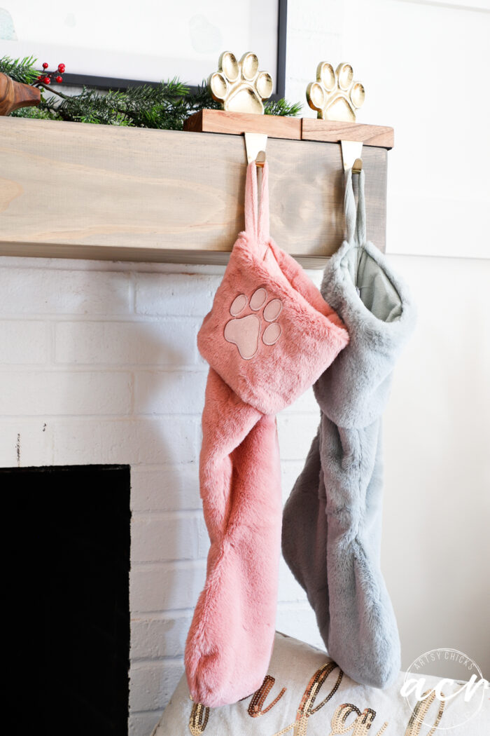 pink and gray puppy stockings hanging from pawprint stocking holders